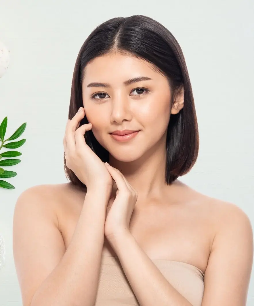 Woman with glowing skin applying skincare cream – skin care product promotion.