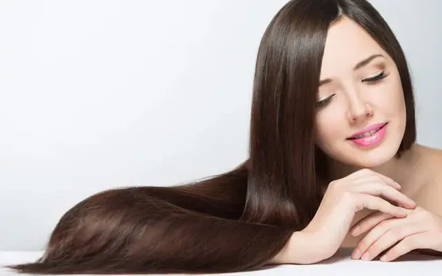 Woman with long, smooth hair – hair care and hair treatment product display.